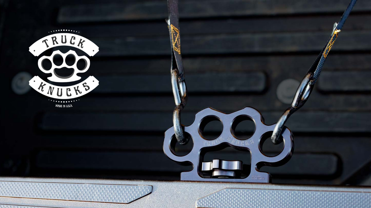 Black Truck Knucks billet aluminum tie down anchor with straps attached in Toyota Tundra truck bed